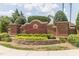 The Kitts Creek neighborhood entrance with lush landscaping and decorative brick signage at 2122 Aventon Ln, Morrisville, NC 27560