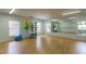A light-filled exercise room features a wood floor, mirrored walls, and equipment at 2122 Aventon Ln, Morrisville, NC 27560