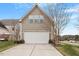 Attached two-car garage with a paved driveway and manicured landscaping at 2122 Aventon Ln, Morrisville, NC 27560