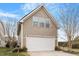 Attached two-car garage with a paved driveway and manicured landscaping at 2122 Aventon Ln, Morrisville, NC 27560