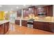 Well-equipped kitchen features stainless steel appliances, granite countertops, and dark wood cabinets at 2122 Aventon Ln, Morrisville, NC 27560