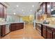 Spacious kitchen featuring granite countertops, stainless steel appliances, and dark wood cabinets at 2122 Aventon Ln, Morrisville, NC 27560