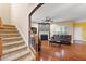 Bright living room has a fireplace, staircase, hardwood floors, and a ceiling fan at 2122 Aventon Ln, Morrisville, NC 27560