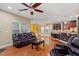 Open-concept living room with hardwood floors, a fireplace, and a partial view of the kitchen at 2122 Aventon Ln, Morrisville, NC 27560
