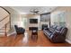 Inviting living room with hardwood floors, fireplace, and comfortable leather seating at 2122 Aventon Ln, Morrisville, NC 27560