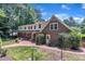A two-story home with a brick and white siding exterior and a brick patio at 2204 Basil Drive, Raleigh, NC 27612