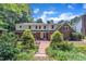 Backyard featuring brick patio, mature landscaping, and lush greenery at 2204 Basil Drive, Raleigh, NC 27612