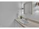 Bathroom with a vanity, white cabinets, and unique wall-mounted lighting fixtures at 2204 Basil Drive, Raleigh, NC 27612