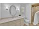 Bathroom featuring a single sink vanity, a walk-in shower, and ample natural light at 2204 Basil Drive, Raleigh, NC 27612