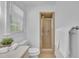 Bathroom showcasing a walk-in shower, a window, and a toilet at 2204 Basil Drive, Raleigh, NC 27612