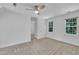 Bright bedroom with carpet, two windows allowing natural light in, and a modern ceiling fan at 2204 Basil Drive, Raleigh, NC 27612