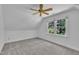 Cozy carpeted bedroom with bright window, ceiling fan, offering ample natural light at 2204 Basil Drive, Raleigh, NC 27612