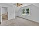 Carpeted bedroom with natural light, a closet, and a ceiling fan, offering comfort and convenience at 2204 Basil Drive, Raleigh, NC 27612