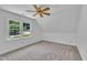 Bright bedroom with carpet, natural light, and a ceiling fan, offering comfortable space at 2204 Basil Drive, Raleigh, NC 27612