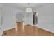Bright dining room featuring wood floors, white walls, and a modern chandelier fixture at 2204 Basil Drive, Raleigh, NC 27612