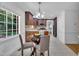 Charming eat-in kitchen featuring a glass table, updated cabinets, and modern appliances at 2204 Basil Drive, Raleigh, NC 27612
