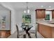 Charming dining area with a glass table and a large window with lush green view at 2204 Basil Drive, Raleigh, NC 27612