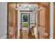 Inviting entryway featuring hardwood floors and decorative wood doors on either side at 2204 Basil Drive, Raleigh, NC 27612