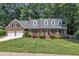 Charming brick home with dormer windows, two-car garage, and a well-manicured lawn at 2204 Basil Drive, Raleigh, NC 27612