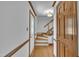 Bright foyer with hardwood floors, a staircase, and a leaded glass front door at 2204 Basil Drive, Raleigh, NC 27612