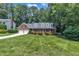 Traditional brick home with lush green lawn and mature trees providing shade at 2204 Basil Drive, Raleigh, NC 27612