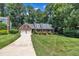 Charming brick home with well-manicured lawn, mature trees, and two-car garage at 2204 Basil Drive, Raleigh, NC 27612