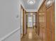 Hallway with hardwood floors, wooden doors, and ample closet space for storage at 2204 Basil Drive, Raleigh, NC 27612
