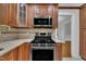 Updated kitchen with stainless steel microwave and range, quartz countertops, and custom cabinets at 2204 Basil Drive, Raleigh, NC 27612