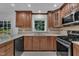Kitchen showcasing stainless steel appliances, quartz countertops, and custom cabinetry at 2204 Basil Drive, Raleigh, NC 27612