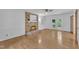 Living room with fireplace, wood floors, natural light, and access to the backyard at 2204 Basil Drive, Raleigh, NC 27612