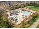 Aerial view of community pool and splash pad including clubhouse and playground at 228 Grantwood Dr, Holly Springs, NC 27540
