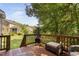 Inviting wooden deck featuring a fireplace and outdoor seating with a lush backyard view at 228 Grantwood Dr, Holly Springs, NC 27540