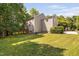 Beautiful backyard featuring a well-maintained lawn and exterior view of the home and deck at 228 Grantwood Dr, Holly Springs, NC 27540
