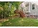 View of the elevated deck from the yard and stair access to the backyard at 228 Grantwood Dr, Holly Springs, NC 27540