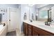 Stylish bathroom with wood cabinets, double sinks, and a large mirror offering a bright and functional space at 228 Grantwood Dr, Holly Springs, NC 27540