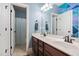 This bathroom has double sinks, a white countertop and cabinet, and decorative wall art at 228 Grantwood Dr, Holly Springs, NC 27540