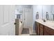 Bathroom with wooden cabinetry, dual sinks, and a soaking tub providing functionality and relaxation at 228 Grantwood Dr, Holly Springs, NC 27540
