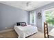 Bright bedroom with natural light, a white quilt, and a ceiling fan for comfort at 228 Grantwood Dr, Holly Springs, NC 27540