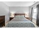 Bedroom with a wooden bed frame, decorative pillows, and bedside tables, providing a comfortable and stylish retreat at 228 Grantwood Dr, Holly Springs, NC 27540