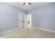 Bright bedroom with a double door closet, neutral walls, and carpeted flooring at 228 Grantwood Dr, Holly Springs, NC 27540