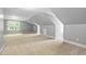 Open bonus room with dormer windows and a spacious layout, ideal for Gathering gatherings at 228 Grantwood Dr, Holly Springs, NC 27540