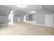 Spacious bonus room with sloped ceilings, neutral carpet, and ample space for various activities at 228 Grantwood Dr, Holly Springs, NC 27540