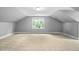 Bright, open bonus room with dormer windows, neutral carpet, and plenty of natural light at 228 Grantwood Dr, Holly Springs, NC 27540