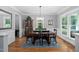 Elegant dining room with a spacious table, chandelier, and natural lighting at 228 Grantwood Dr, Holly Springs, NC 27540