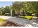 Well-maintained home exterior with a lush front yard, mature trees, and a paved driveway at 228 Grantwood Dr, Holly Springs, NC 27540