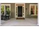 Charming front porch with rocking chair seating, with brick accents and stylish decor at 228 Grantwood Dr, Holly Springs, NC 27540