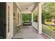 Spacious front porch with a swing, providing a relaxing outdoor area and curb appeal at 228 Grantwood Dr, Holly Springs, NC 27540