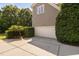 Attached two-car garage with a clean driveway and manicured landscaping at 228 Grantwood Dr, Holly Springs, NC 27540