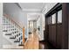 Stylish hallway with hardwood floors, staircase and decorative coat rack at 228 Grantwood Dr, Holly Springs, NC 27540
