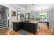 Kitchen island with a cooktop offers seamless transition to the dining area at 228 Grantwood Dr, Holly Springs, NC 27540